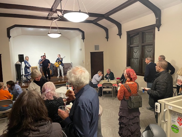 A birthday gathering with live music in the main meeting room
