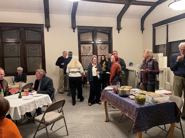 Guests mingling at a birthday gathering in the main meeting room