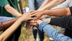 A group of people's hands piled up.